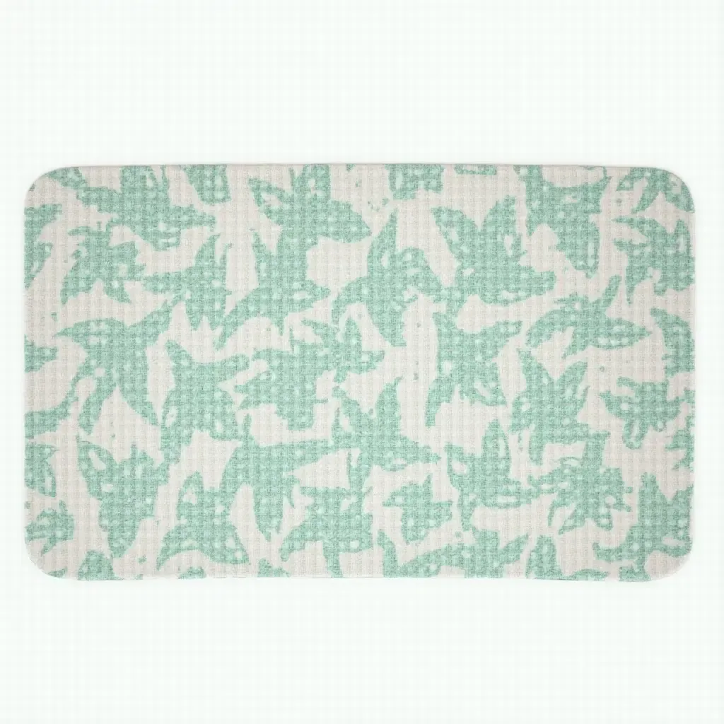 a photo of a patterned bath mat with tropical leaves