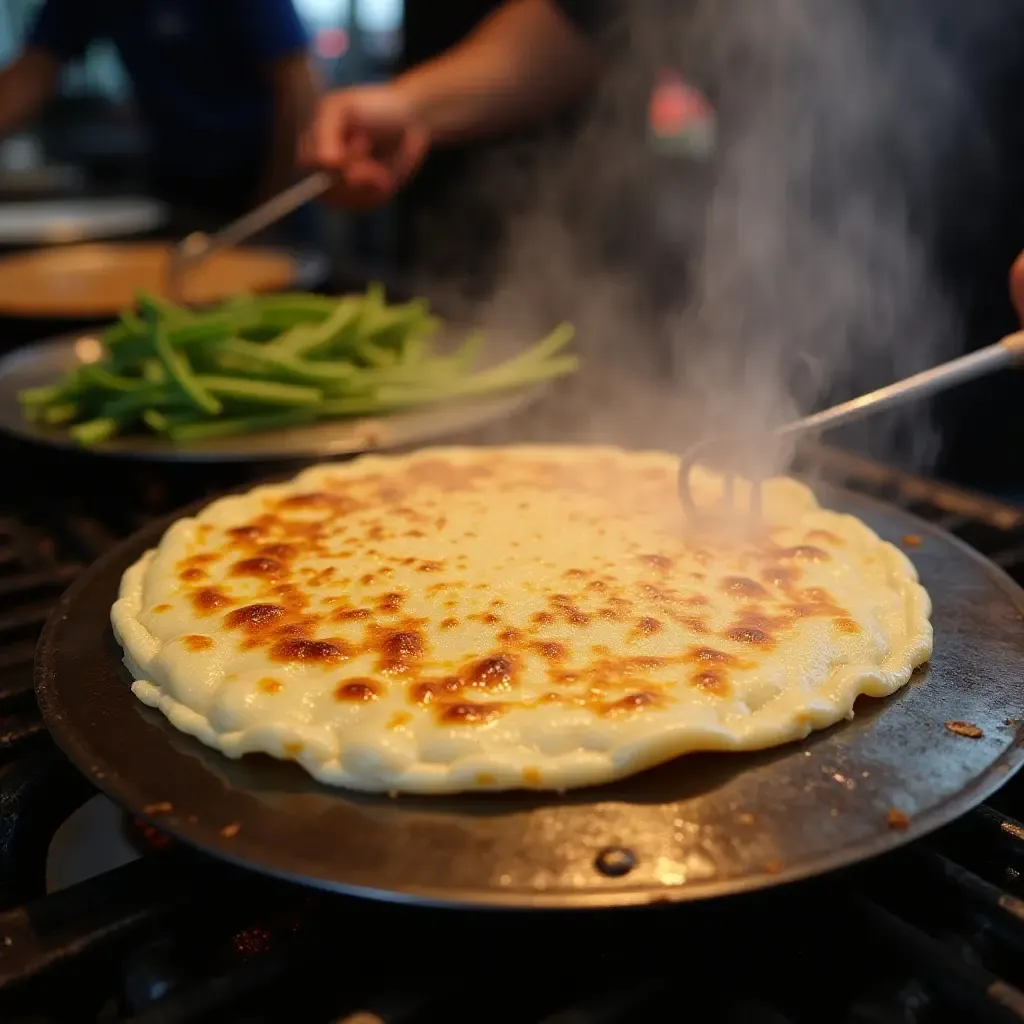 a photo of Congyoubing, a savory scallion pancake with flaky layers, being cooked on a street cart.