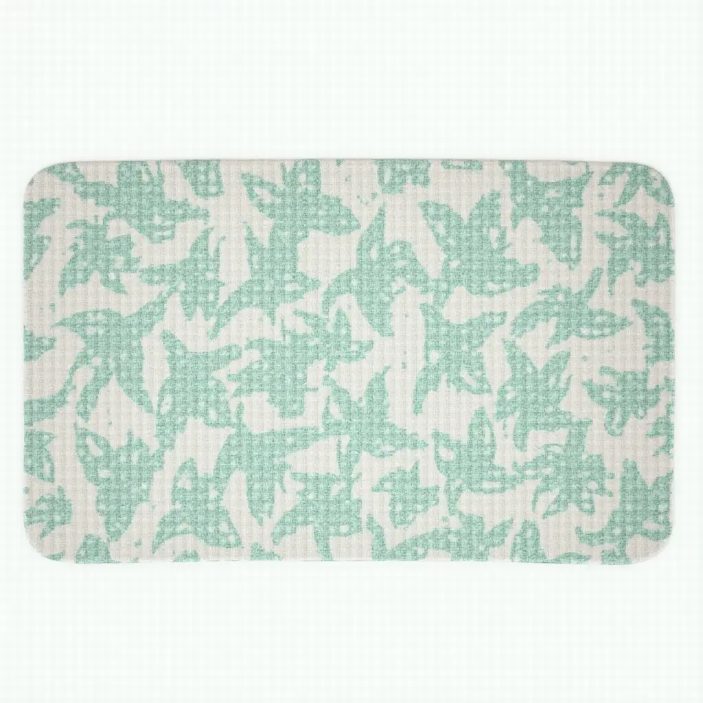 a photo of a patterned bath mat with tropical leaves